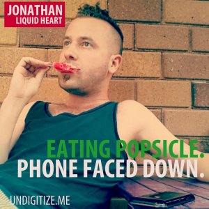 Eating Popsicle. Phone Faced Down.