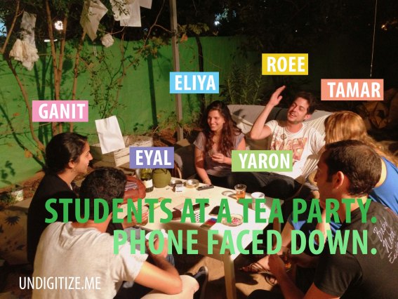 Students At A Tea Party. Phones Faced Down.