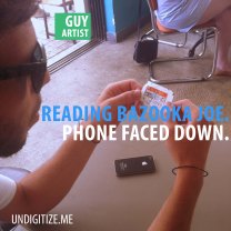 Reading Bazooka Joe. Phone Faced Down.