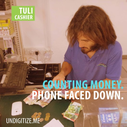 Counting Money. Phone Faced Down.